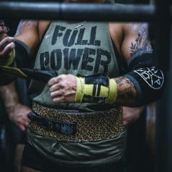 Person wearing athletic gear, including gloves and a tank top that says "FULL POWER."