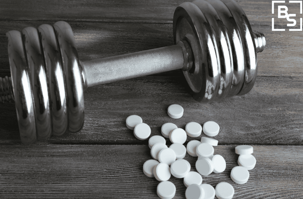 Tablets and dumbbell on the table