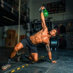 Men lifting kettlebell in black short