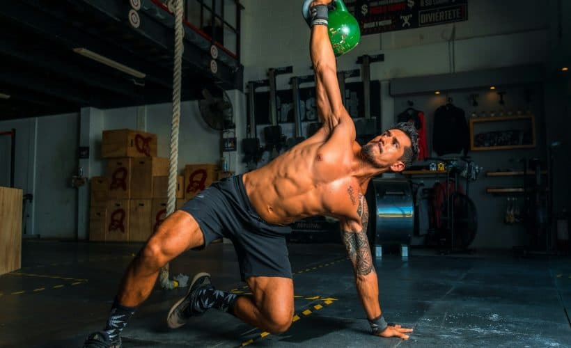 Men lifting kettlebell in black short