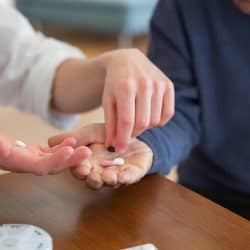 Two people exchanging pills