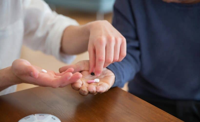 Two people exchanging pills