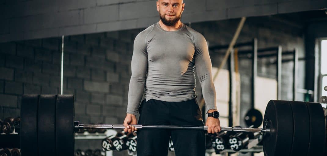 Strong man exercising at the gym