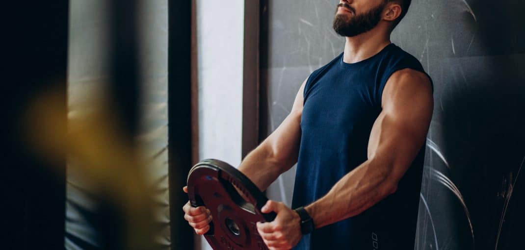 Strong man training in gym