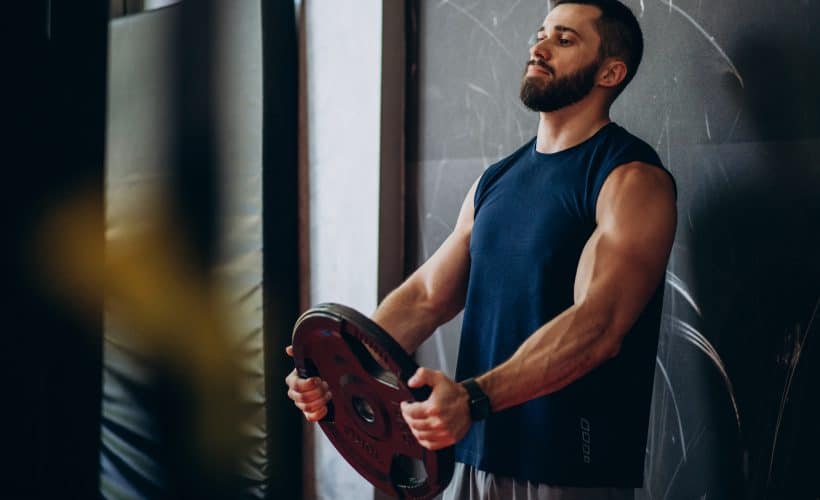 Strong man training in gym