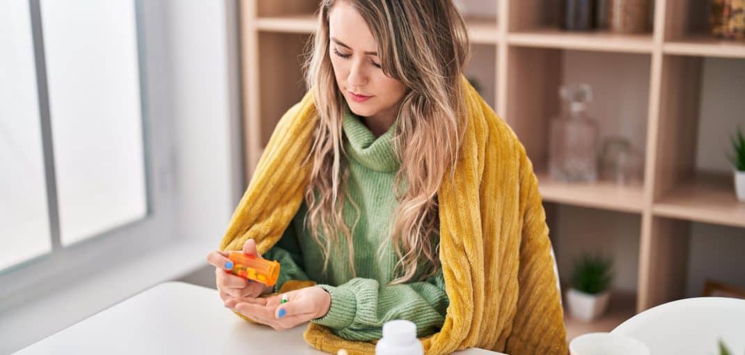 Woman taking pills at home