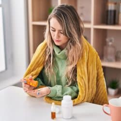 Woman taking pills at home